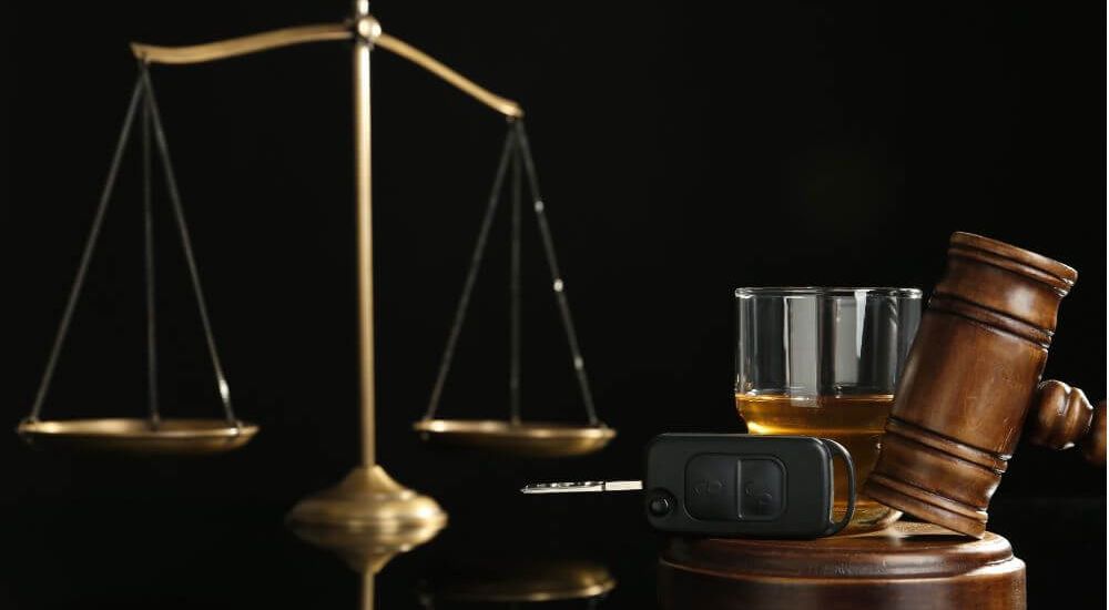 a scale and a gavel sitting on a defense lawyer's desk