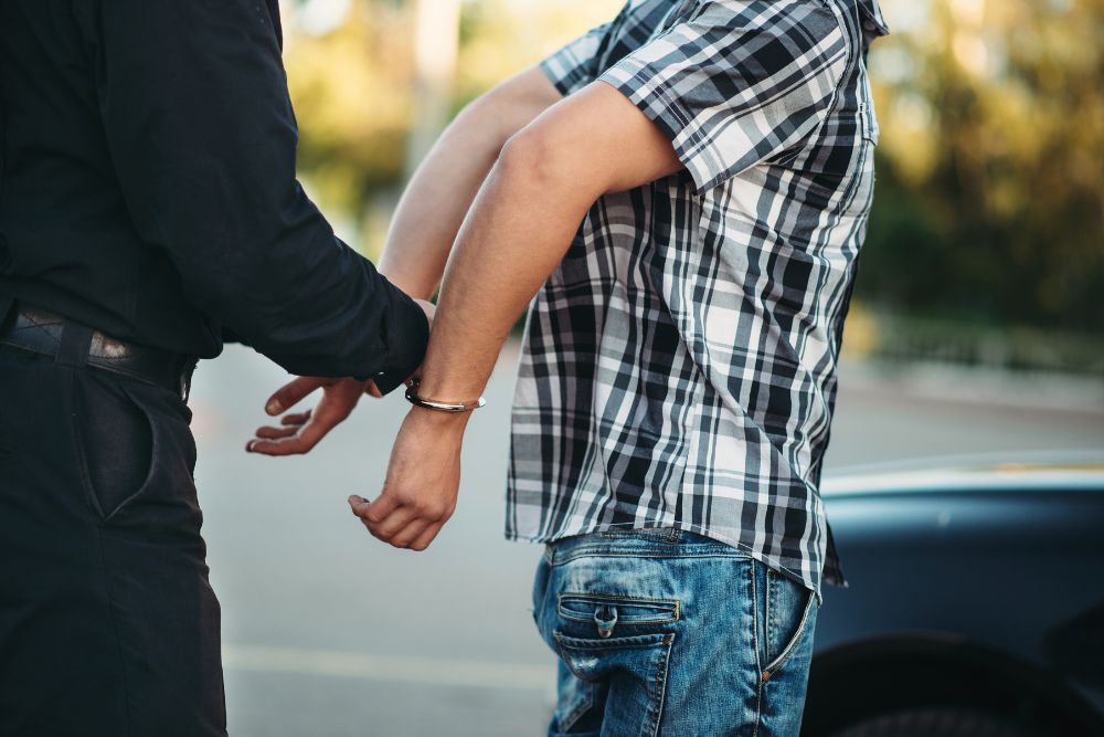 Policeman arrests a speeding driver on road